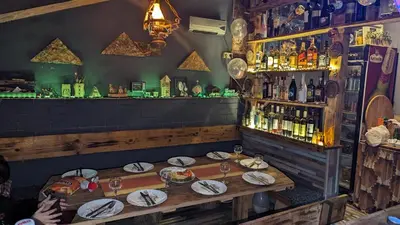 a bar with plates of food on a wooden table at Nature Neno in Visoko