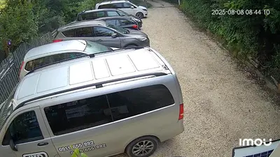 a row of cars parked on a dirt road at Nature Neno in Visoko