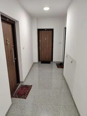 an empty hallway with two doors and a rug at Apartman IDEA Tuzla in Tuzla