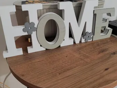 a sign that says love on top of a wooden table at Apartman IDEA Tuzla in Tuzla