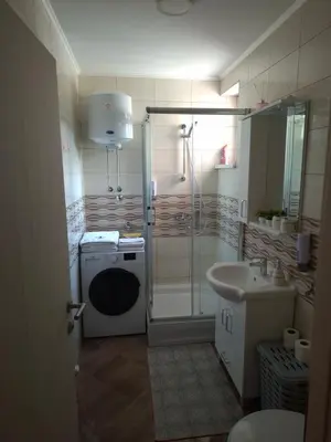 a bathroom with a shower and a sink at Apartman IDEA Tuzla in Tuzla