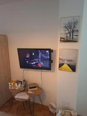 a flat screen tv hanging on a wall at Apartman IDEA Tuzla in Tuzla
