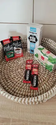 a wicker basket with snacks and a box of sushi at Apartman IDEA Tuzla in Tuzla