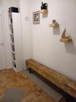 a room with a wooden bench on the wall at The Orchid in Jajce