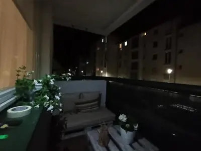 a balcony with a couch and plants on a building at The Orchid in Jajce