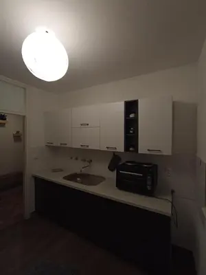 a kitchen with a sink and a microwave on a counter at The Orchid in Jajce