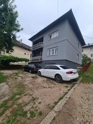 a white car parked in front of a house at Apartman Dani in Jajce