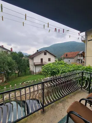 a balcony with chairs and a view of a mountain at Apartman Dani in Jajce