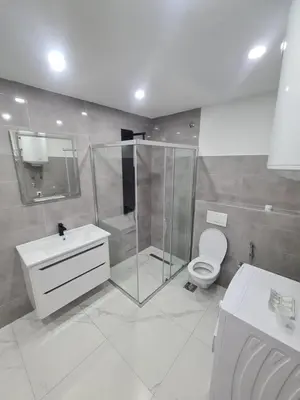 a bathroom with a shower and a toilet and a sink at Apartman Dani in Jajce