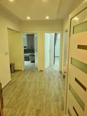 an open door to a living room with wood floors at Apartman Dani in Jajce
