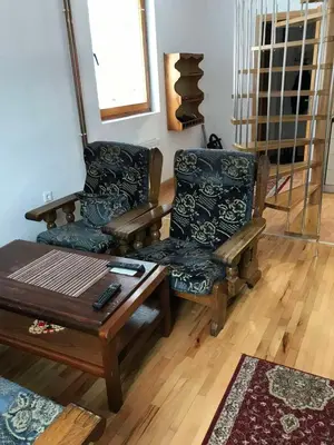 a living room with two chairs and a coffee table at Vila Damir in Gornja Šišava