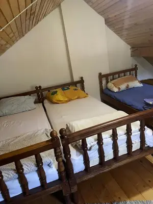 two bunk beds in a room with a attic at Vila Damir in Gornja Šišava