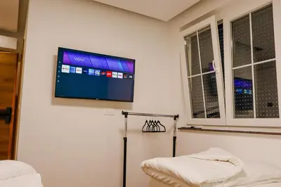 a room with a flat screen tv on a wall at Villa Ali in Illidža