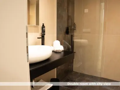 a bathroom with a white sink and a shower at Lala in Bosanska Krupa