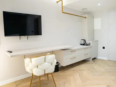 a white desk with a television on a wall at Lala in Bosanska Krupa
