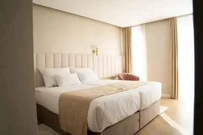 a bedroom with a large white bed and a window at Lala in Bosanska Krupa