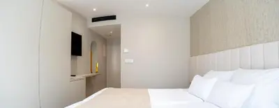 a bedroom with a white bed with white pillows at Lala in Bosanska Krupa