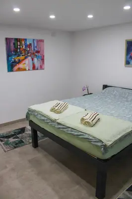 a bed in a room with at Apartman Nadja&Dani in Kulen Vakuf