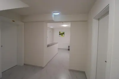 an empty room with white walls and a hallway at Tadic apartments and rooms by the shore of Rama Lake in Prozor