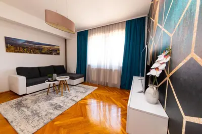 a living room with a couch and a table at Khalilah Apartment 1 in Bihać