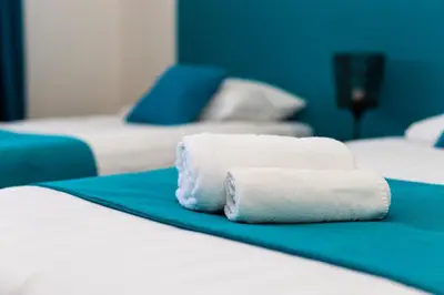two towels are sitting on top of two beds at Khalilah Apartment 1 in Bihać