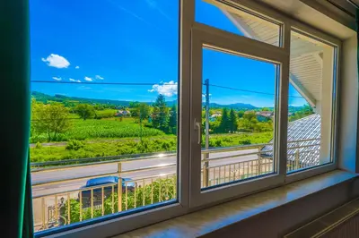 a window with a view of the mountains at Khalilah Apartment 2 in Bihać