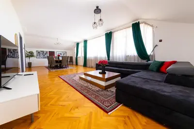 a living room with a couch and a table at Khalilah Apartment 2 in Bihać