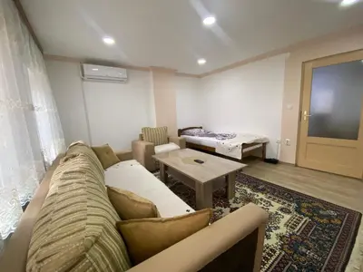 a living room with a couch and a table at Apartment Poturmahala 2 in Travnik