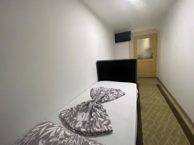 a room with a bed and a chair in it at Apartment Poturmahala 2 in Travnik