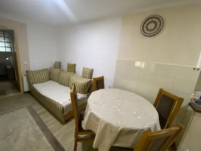 a living room with a table and a couch at Apartment Poturmahala 2 in Travnik