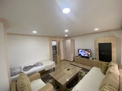 a living room with a couch and a table at Apartment Poturmahala 2 in Travnik