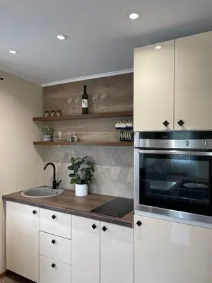 a kitchen with a sink and a microwave at Bungalovi izvor Plive 2 in Šipovo