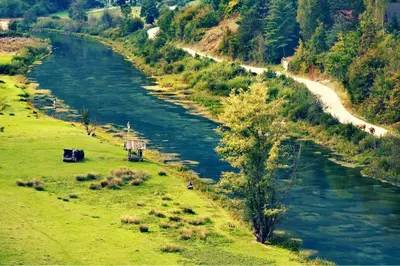 an aerial view of a river in a field at Bungalovi izvor Plive 2 in Šipovo
