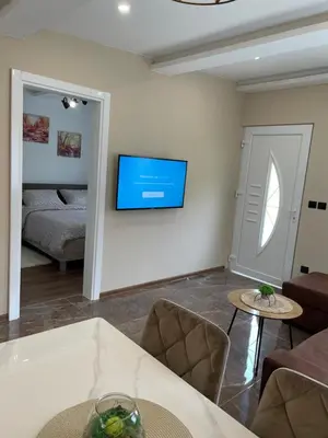 a living room with a television on a wall at Bungalovi izvor Plive 2 in Šipovo