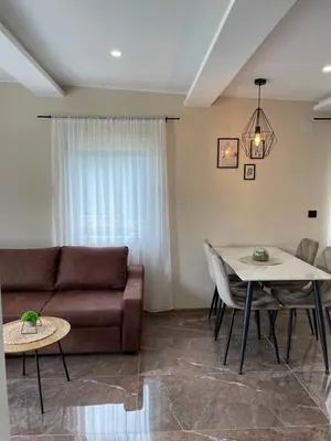 a living room with a couch and a table at Bungalovi izvor Plive 2 in Šipovo