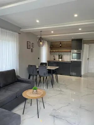 a living room with a couch and a table at Bungalovi izvor Plive 3 in Šipovo