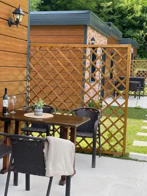 a patio with a table and chairs and a fence at Bungalovi izvor Plive 3 in Šipovo