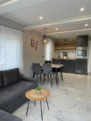 a living room with a couch and a table at Bungalovi izvor Plive 3 in Šipovo
