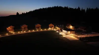 a row of houses lit up at night with lights at Luxury Glamping Grabovica - Vital Resort in Skender Vakuf