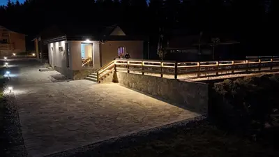 a building with a fence and a walkway at night at Luxury Glamping Grabovica - Vital Resort in Skender Vakuf