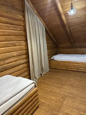 a bedroom with two beds in a wooden cabin at Luxury Glamping Grabovica - Vital Resort in Skender Vakuf