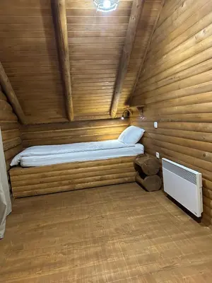 a small room with a bed in a wooden cabin at Luxury Glamping Grabovica - Vital Resort in Skender Vakuf