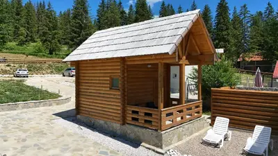 a small wooden building with two chairs and a roof at Luxury Glamping Grabovica - Vital Resort in Skender Vakuf