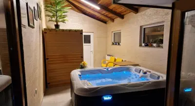 a jacuzzi tub in the middle of a room at Villa, Vikendica - Sunny Hill - jacuzzi, sauna in Banja Luka
