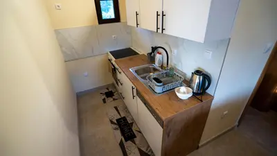 a small kitchen with a sink and a counter at Villa, Vikendica - Sunny Hill - jacuzzi, sauna in Banja Luka