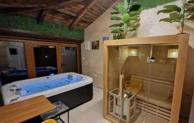 a bathroom with a blue tub and a glass shower at Villa, Vikendica - Sunny Hill - jacuzzi, sauna in Banja Luka