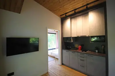 a kitchen with a flat screen tv on the wall at ORAH HOUSE, a unique and unforgettable vacation on a private island in Bihać