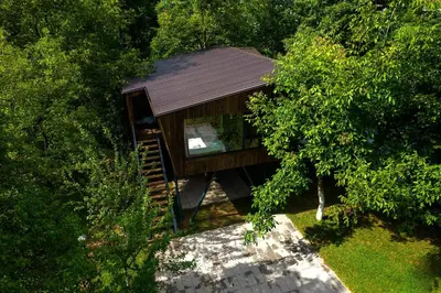an overhead view of a tree house in the woods at ORAH HOUSE, a unique and unforgettable vacation on a private island in Bihać