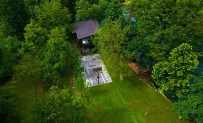 an overhead view of a house in the middle of a field at ORAH HOUSE, a unique and unforgettable vacation on a private island in Bihać
