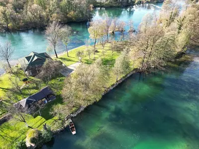 an aerial view of an island in a river at ORAH HOUSE, a unique and unforgettable vacation on a private island in Bihać